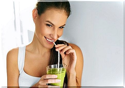 woman drinking green smoothie