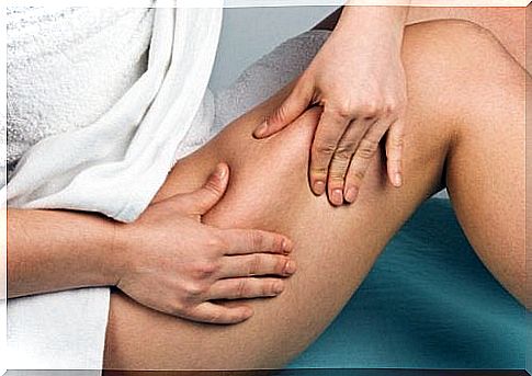 A woman squeezes her cellulite