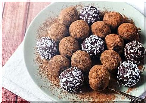 Homemade chocolate truffles decorated with coconut chips and cocoa powder