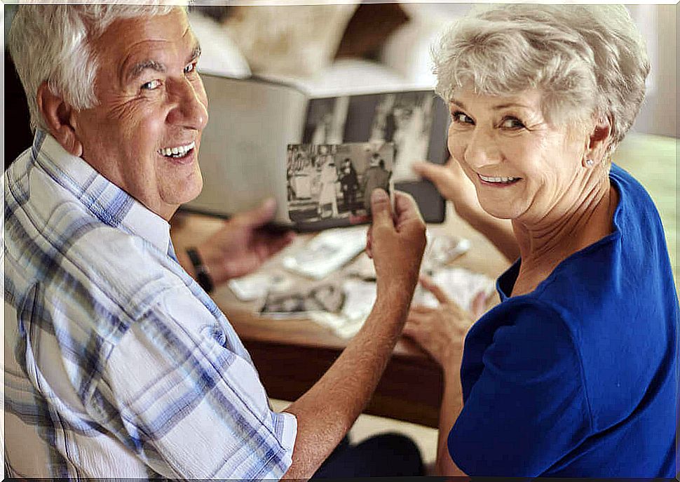 An old couple looking at photos.