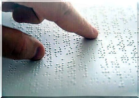 A blind person gets help from braille